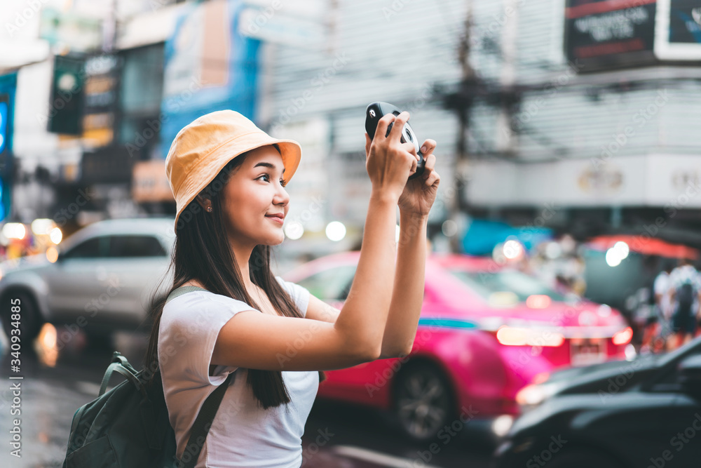 vintage style asian woman with instant camera in Bangkok, Thailand