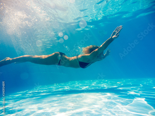 Woman underwater at the pool