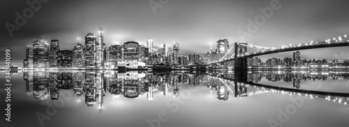 Photography .New York City skyline with skyscrapers at sunset on Brooklyn Bridge black and w