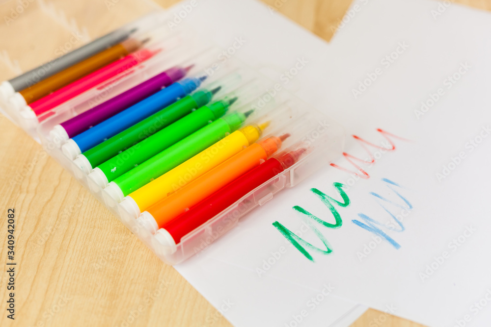 Fototapeta premium Felt-tip pens, pencils in boxes, different colors, the order on the table, the work of the child, home creation and order, the joy of drawing, school desk and quarantine