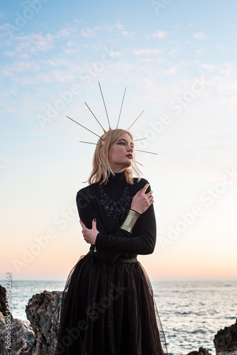 young girlon the sea in a black long dress photo