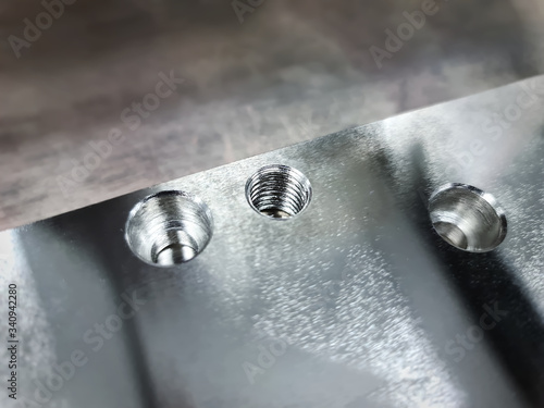 Close-up Threaded Hole and Counterbore Holes on Stainless Steel Plate photo