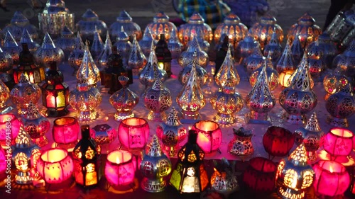 night shot of small metal lanterns with burning candles at a market in marrakech, morroco photo