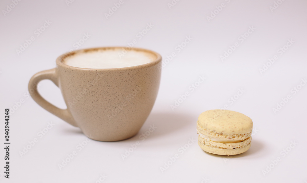 Homemade colorful macaron on the white background.Cup of coffee.