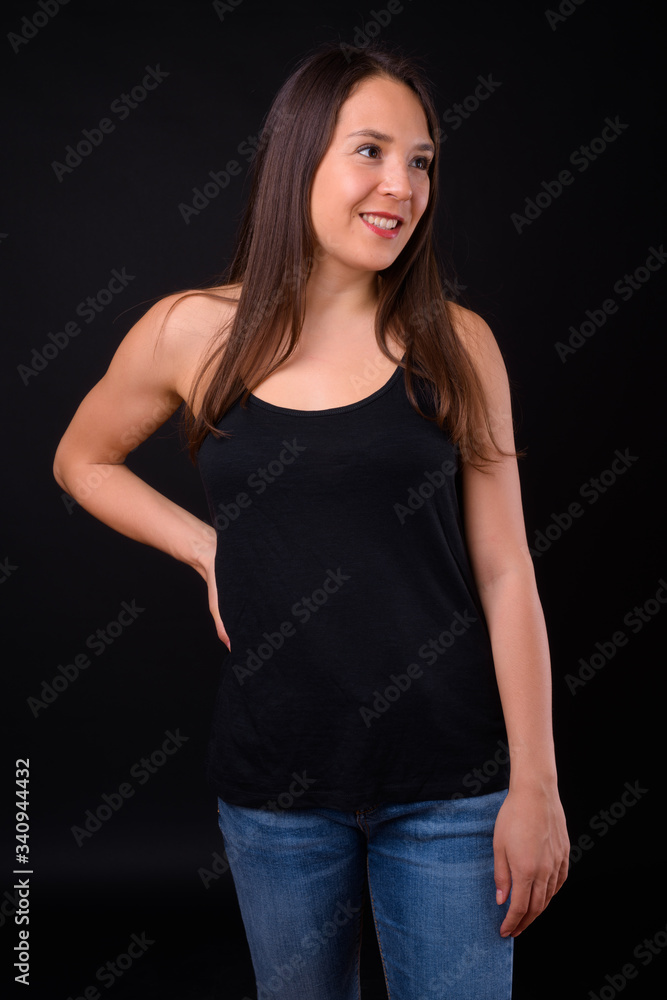 Young multi ethnic beautiful woman against black background Young multi ethnic beautiful woman against black background