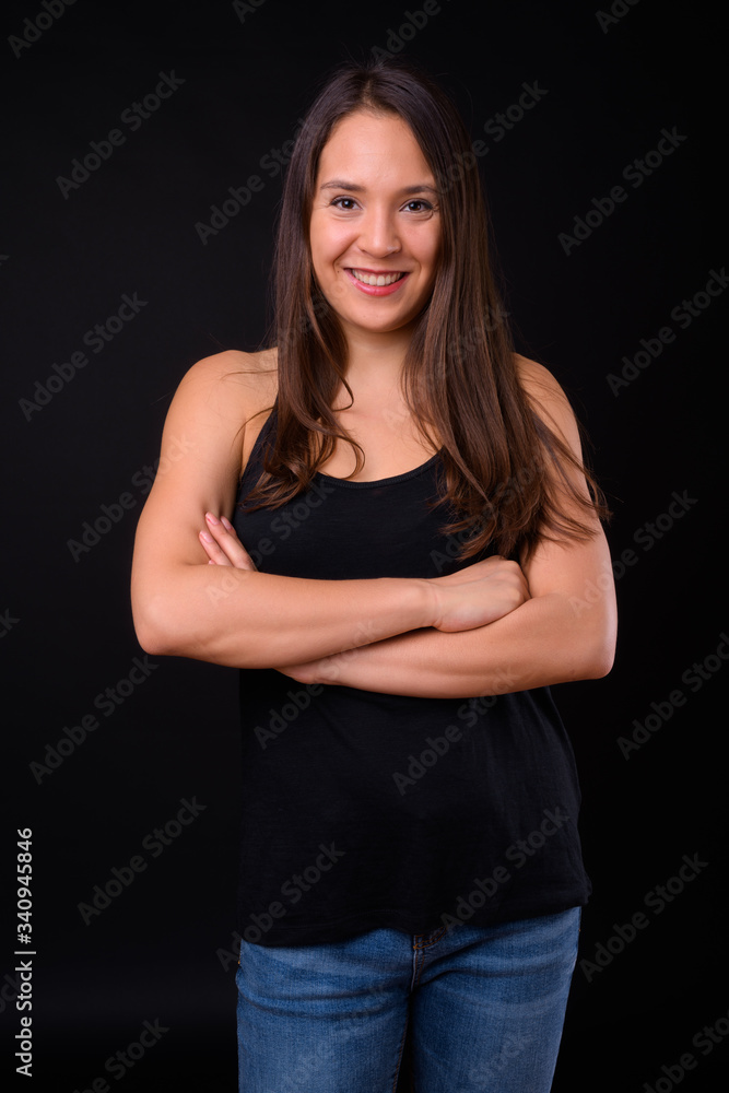 Young multi ethnic beautiful woman against black background Young multi ethnic beautiful woman against black background
