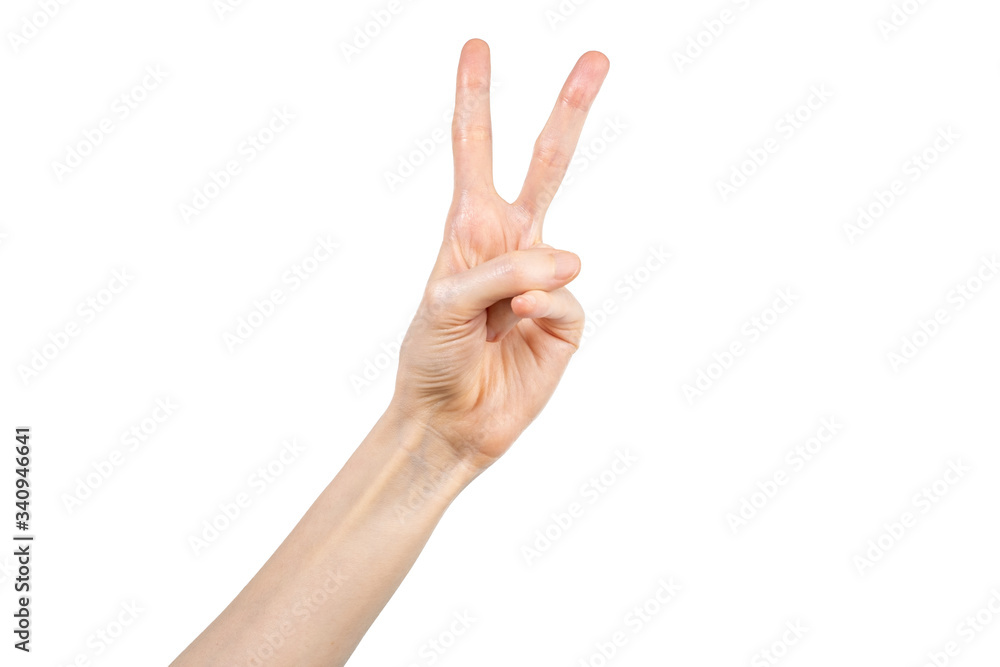 Hand of a Caucasian woman showing victory gesture on white background Hand of a Caucasian woman showing victory gesture on white background