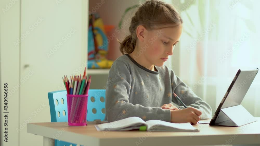 Cute child use laptop for education, online study. Girl has homework at distance learning. Lifestyle concept for Family quarantine covid-19. Cute child use laptop for education, online study. Girl has homework at distance learning. Lifestyle concept for Family quarantine covid-19.
