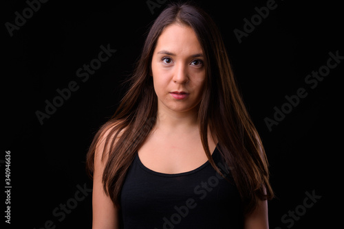 Young multi ethnic beautiful woman against black background