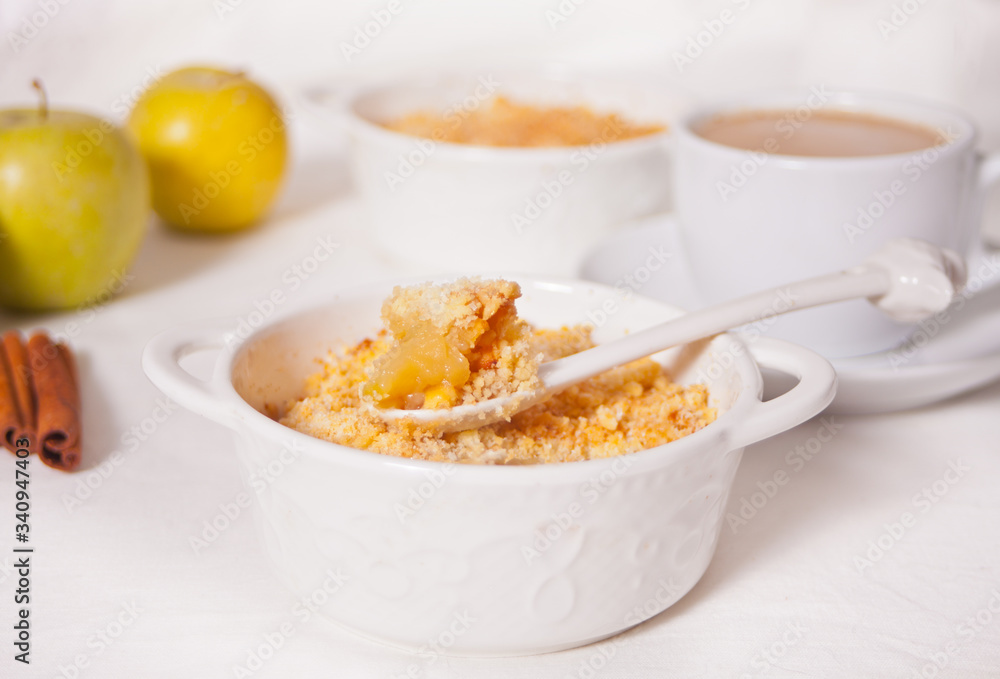 Tasty homemade apple crumble dessert on the white background. Tasty homemade apple crumble dessert on the white background.