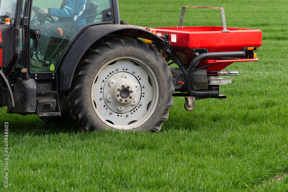 Tractor spreading artificial fertilizers Tractor spreading artificial fertilizers