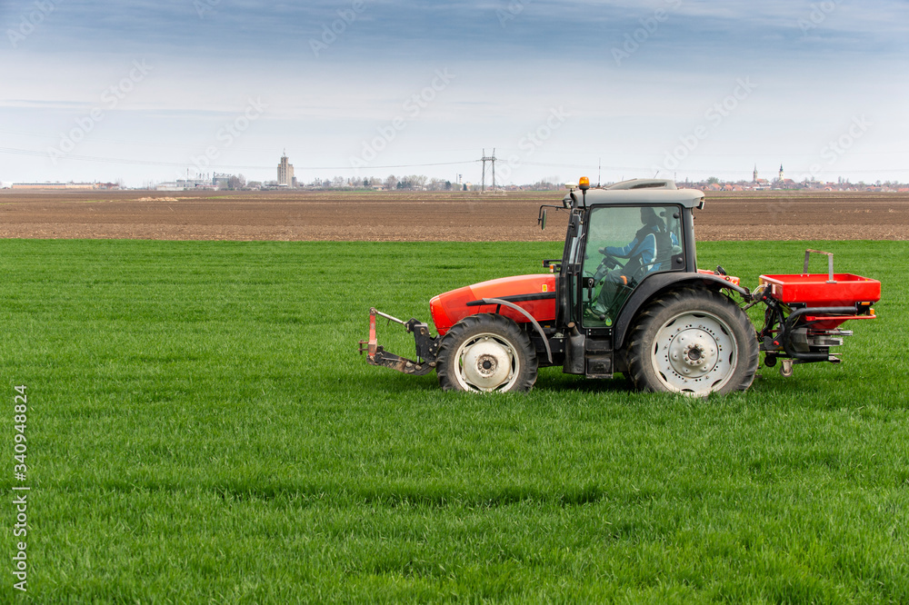 Tractor spreading artificial fertilizers