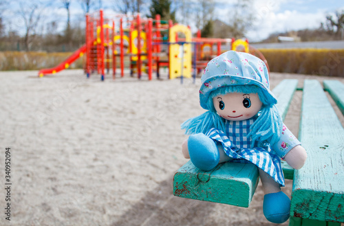 forgotten toy doll in the empty quarantined playground