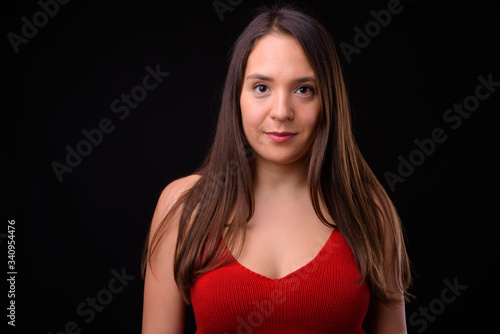Young multi ethnic beautiful woman against black background