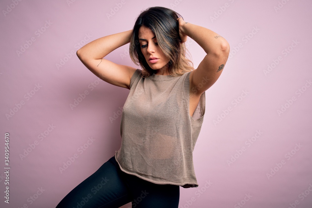 Young beautiful woman wearing fashion urban clothes, model wearing casual street style standing over pink background Young beautiful woman wearing fashion urban clothes, model wearing casual street style standing over pink background
