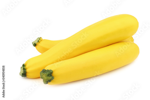 three yellow zucchini's on a white background