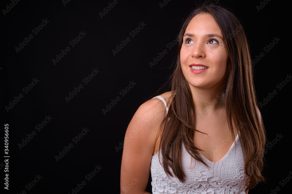 Young multi ethnic beautiful woman against black background Young multi ethnic beautiful woman against black background