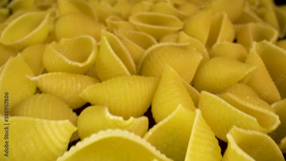 Closeup on a pile of dried conchiglie pasta. Closeup on a pile of dried conchiglie pasta.