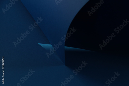 Beautiful dark blue background with lights and shadows. Background with rolled-up paper. Shadow, light, geometric. Trend background. Geometric concept.