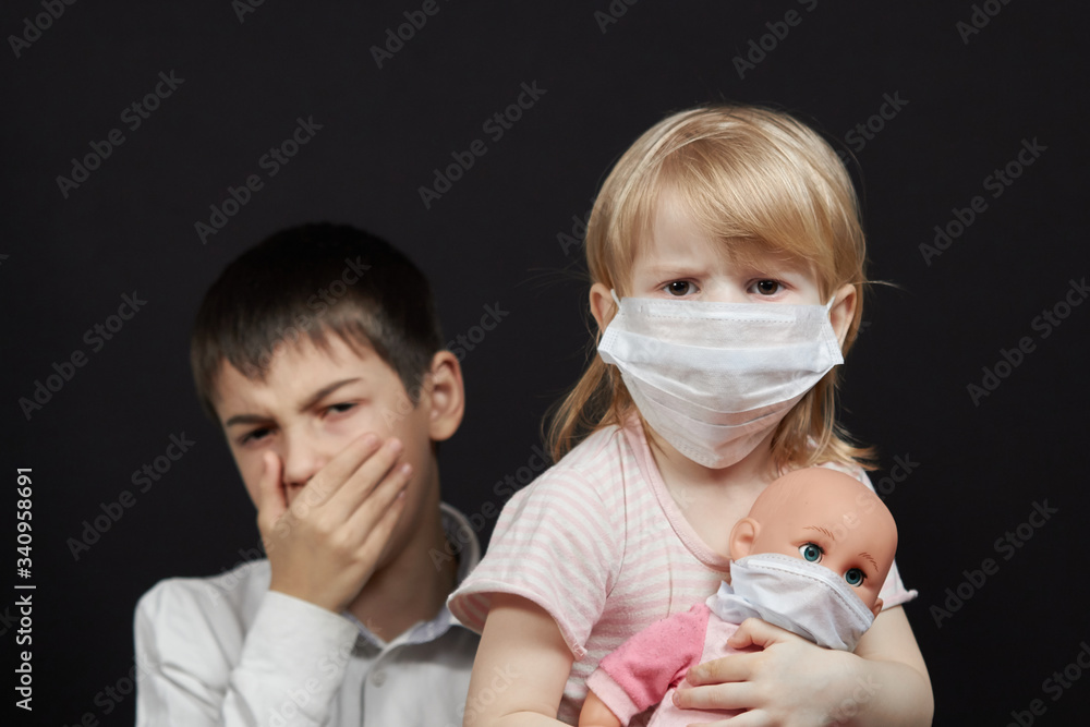 masked girl and boy sneezing, the concept of protection against the spread of the virus medical mask