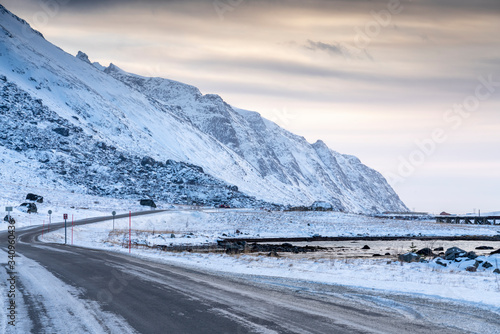  Icy road against snowcapped mountain