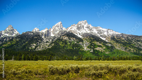 A Snowy Mountain Range in Grand Teton National Park, Wyoming, USA during summer. It’s a popular destination in summer for hiking, camping and fishing, linked to nearby Yellowstone National Park