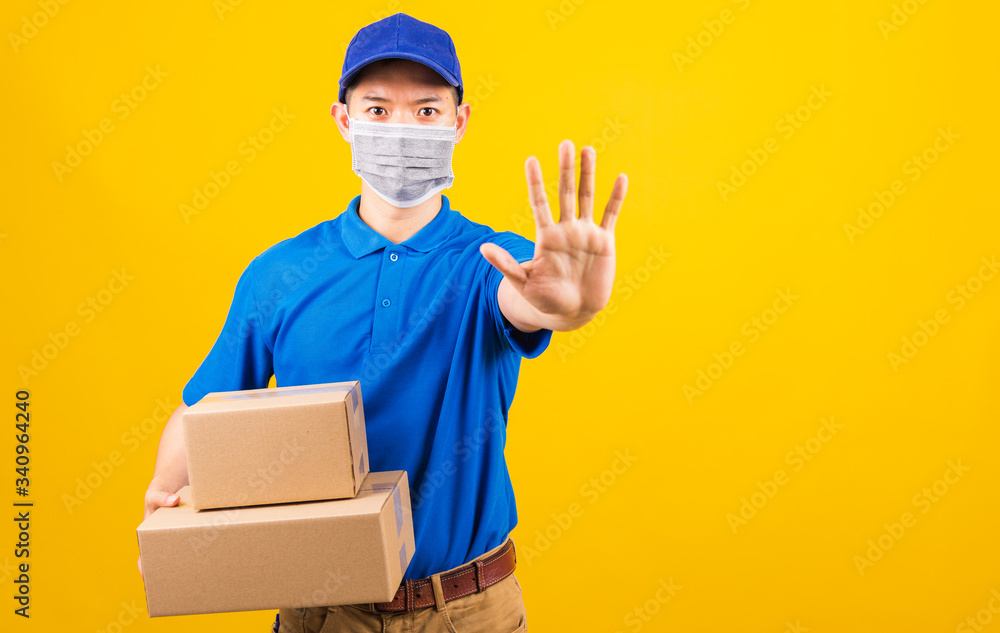 delivery worker man wearing face mask protective hold boxes he raise hand to stop sign delivery worker man wearing face mask protective hold boxes he raise hand to stop sign