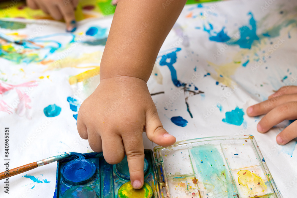 Child paint with watercolors. Education concept. Child paint with watercolors. Education concept.