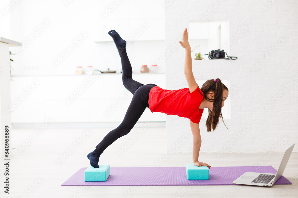 smiling little girl doing exercises at home smiling little girl doing exercises at home