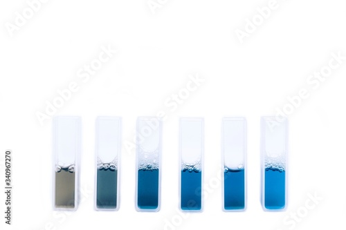 Liquid reagent in quartz or glass cuvettes isolated on white background.