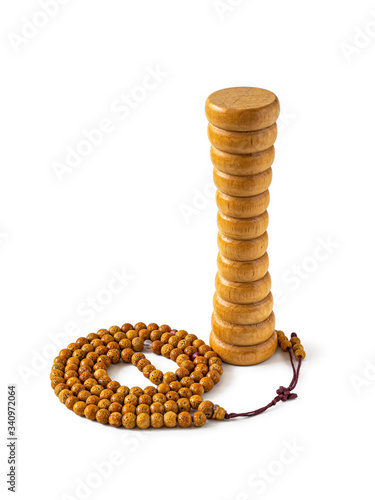 Hand made wooden massager and Buddhist rosary on white background