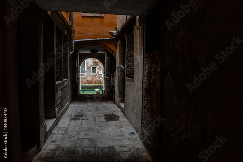 Dark corridor and light exit to the water channel in Venice   VENICE, ITALY - 16 SEPTEMBER 2018.  © Руслан Секачев