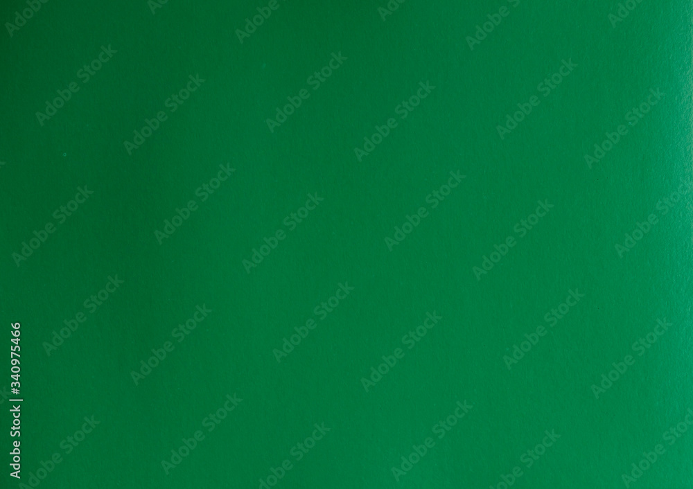The texture of the paper is green. Colored cardboard. Beautiful background. The texture of the paper is green. Colored cardboard. Beautiful background.