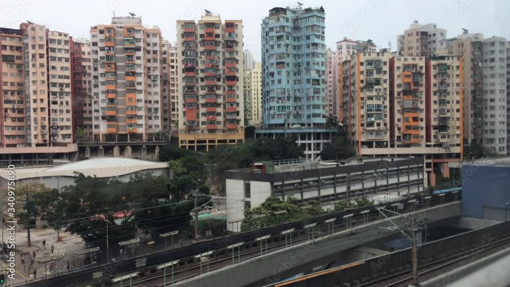 Hong Kong / China Apr 19 2020: Kwun Tong MTR trains in operations, Hong Kong traditional residential buildings in Kung Tong area, Kowloon on Sunday Hong Kong / China Apr 19 2020: Kwun Tong MTR trains in operations, Hong Kong traditional residential buildings in Kung Tong area, Kowloon on Sunday