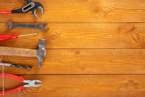 Top view layout of tools for repair on wooden background, free space for text