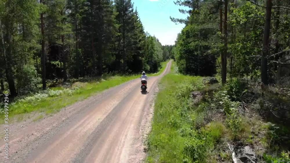 Drone follows motorbike from far. Drone follows motorbike from far.
