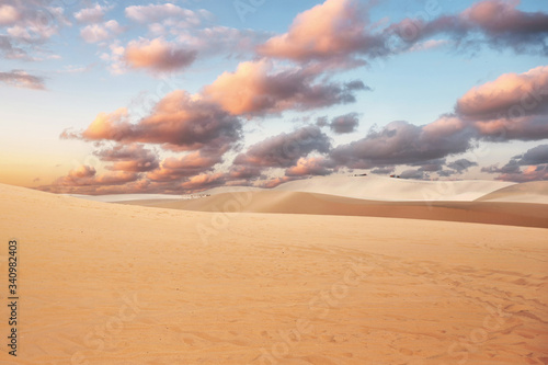 Sand dune with colorful cloud in sky on desert