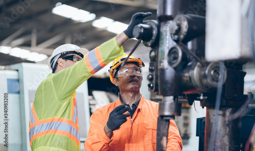 technician Having replacement machine With Mentor In Factory