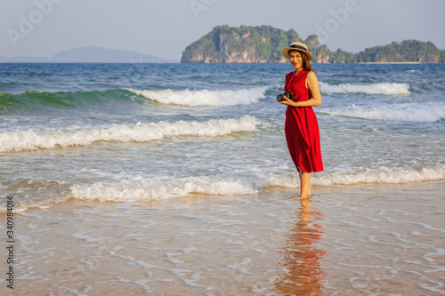 Woman taking photo on beach