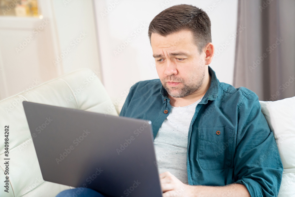 sad male freelancer working online lying on couch. sad male freelancer working online lying on couch.