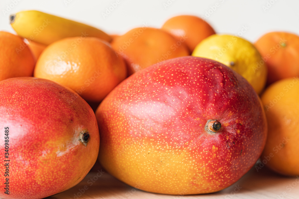 Still-life with mango and citrus close up on white background, isolated. Tasty fruits are natural products and healthy food. Still-life with mango and citrus close up on white background, isolated. Tasty fruits are natural products and healthy food.