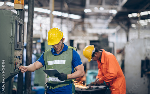 technician engineer control buttom to machinery in factory photo