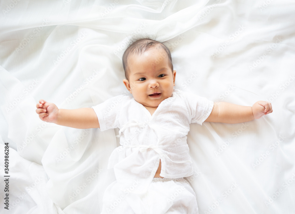 Cute newborn baby girl in white blanket on nursery bed. Adorable new born child, little boy eyes look people Family, new childhood, infant soft skin portrait concept. Jaundice syndrome life hospital. Cute newborn baby girl in white blanket on nursery bed. Adorable new born child, little boy eyes look people Family, new childhood, infant soft skin portrait concept. Jaundice syndrome life hospital.