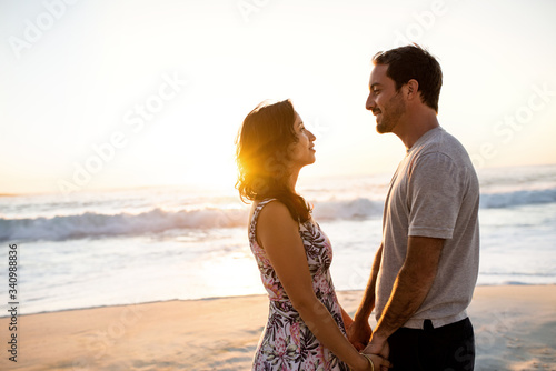 Loving couple looking into each other's eyes on a beach