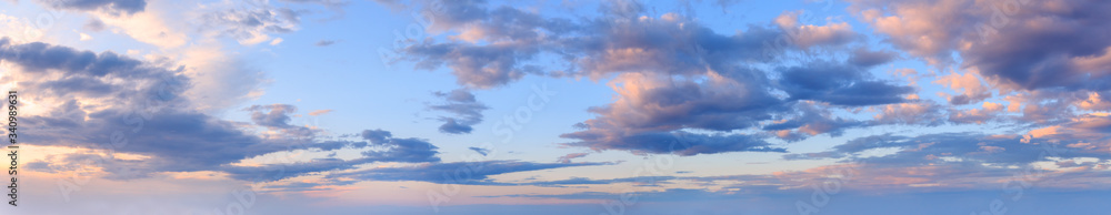 Summer evening sky panorama with fleece clouds background.