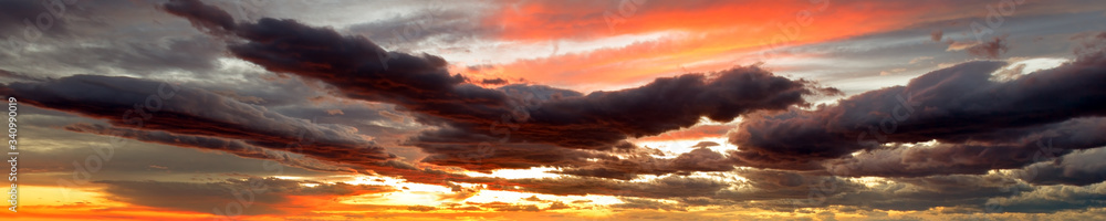 Summer sunset dramatic sky panorama with fleese clouds