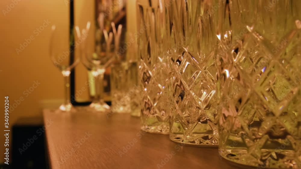 Empty glasses on a shelf. Cocktail glasses in the bar before the party. Lockdown, quarantine, epidemic, crisis concept 4k Empty glasses on a shelf. Cocktail glasses in the bar before the party. Lockdown, quarantine, epidemic, crisis concept 4k