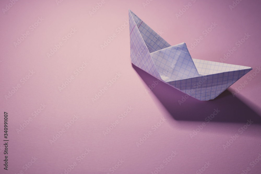 Paper boat on multicolored backgrounds Paper boat on multicolored backgrounds