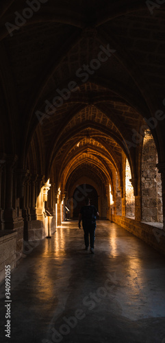 man is walking over the arch in the sunset