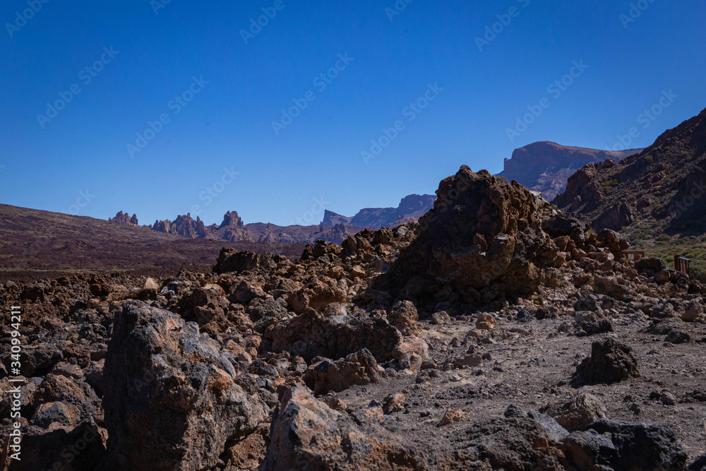 Obraz premium Volcanic rocks in the hills of Tenerife with clear blue skies